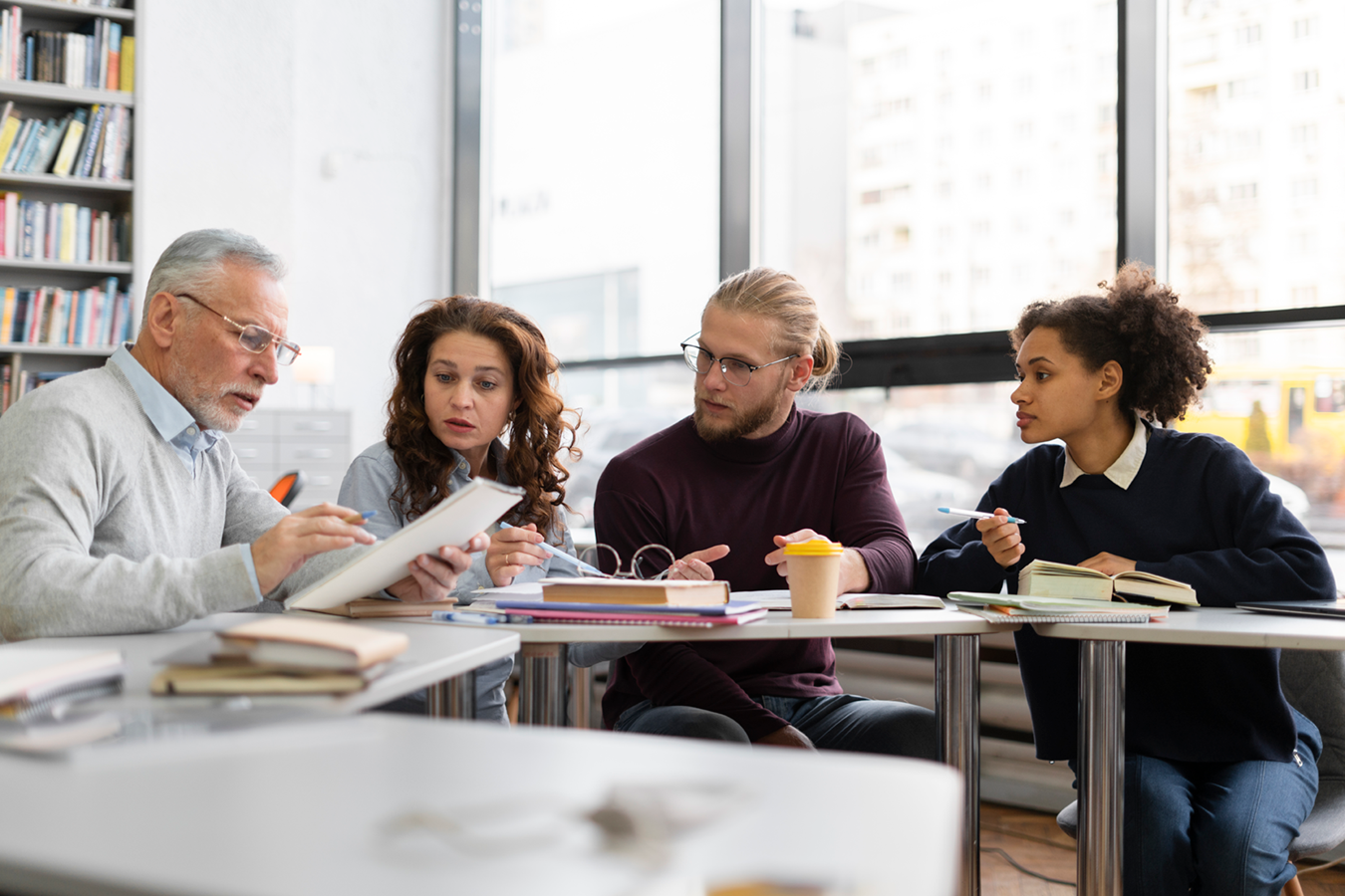 medium-shot-people-sitting-library